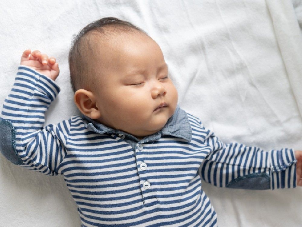 baby-boy-striped-shirt-is-sleeping-bed.jpg