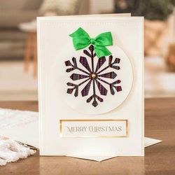 'Snowflake-Themed Christmas Greeting Card with Green Ribbon'