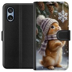 Kompatibelt Lommeboketui til Sony Xperia 10 VI Vinterkanin med lue og skjerf beundrer sjarmerende snøfnugg vinterscene fylt med julestemning