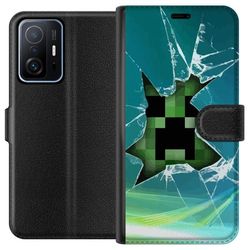 Kompatibelt Lommeboketui til Xiaomi 11T Minimalistiskt spillmotiv med grønn pikselkarakter og blå bakgrunn med glasseffekt