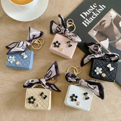 Bolsa de almacenamiento de auriculares de cuero de moda, Mini llavero creativo, colgante de Color sólido, funda para auriculares Bluetooth
