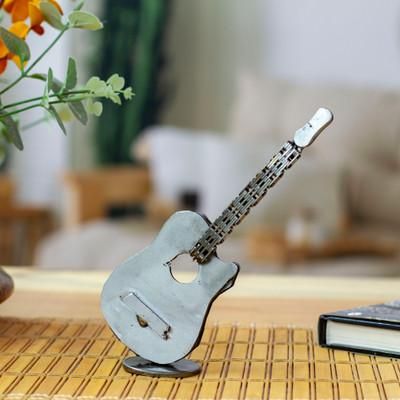 'Guitar-Themed Figurine Handcrafted from Recycled Auto Parts'