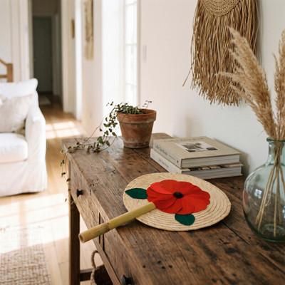 'Hand-Woven Natural Fiber Hand Fan with Red Floral Motif'