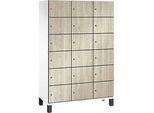 C+P Schliessfachschrank Cambio, 3 Abteile, 18 Fächer, auf Füssen, B 1200 x T 525 x H 1980 mm, verkehrsweiss/Sen Esche‑Dekor