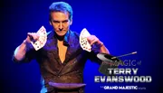 A magician is shown confidently displaying a fan of playing cards on a promotional poster for a magic show at The Grand Majestic Theater.