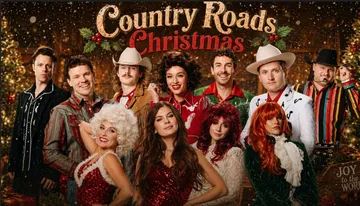 A group of people in festive and country-themed attire pose together under a 