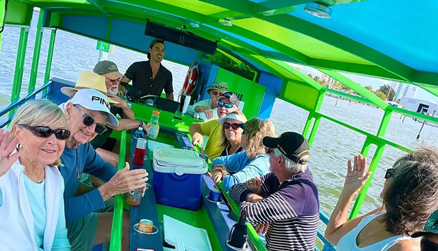A group of people seems to be enjoying a sunny day on a cycleboat, sharing drinks and conversations.