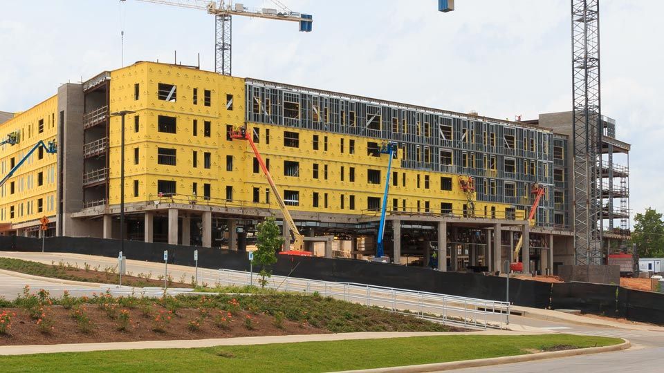 Exterior of multi-story dorm construction of Versa-Dek on steel stud