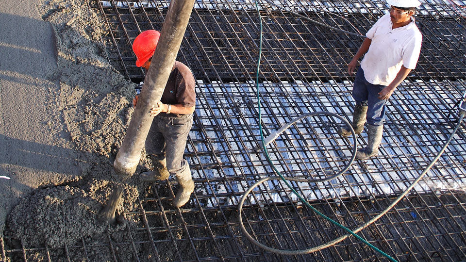 Working guiding flow of concrete onto bridge deck forms