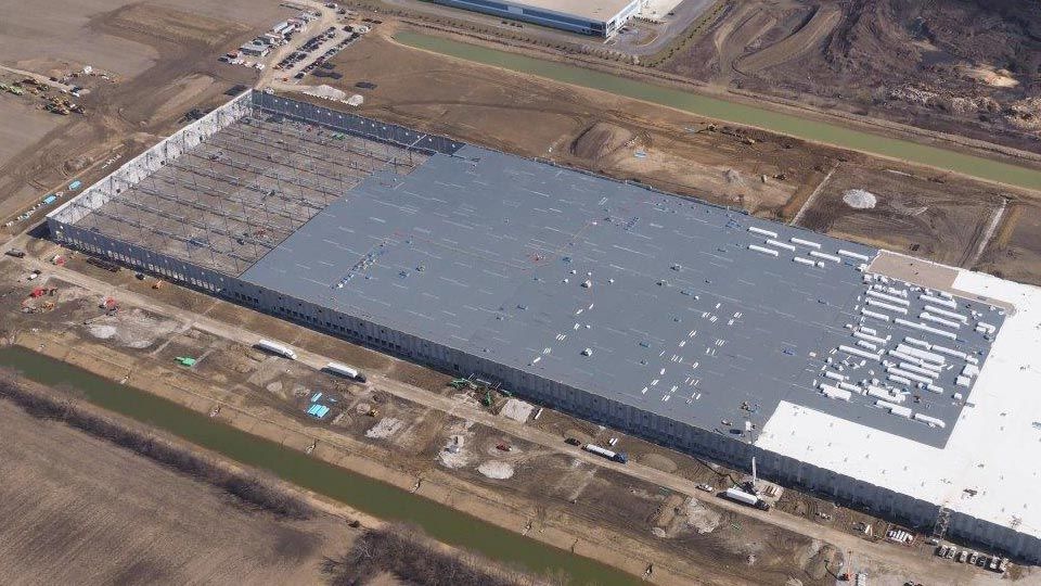 Aerial view on massive warehouse under construction