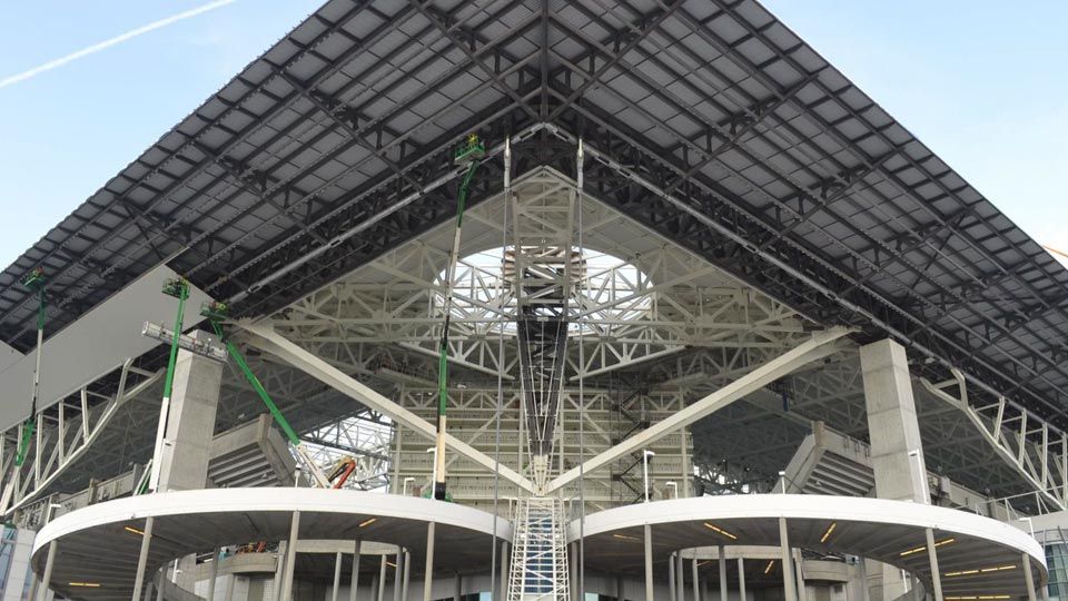 View looking up at the corner of the stadium and its deck-covered canopy