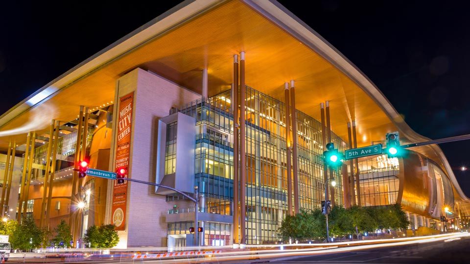 Exterior night photo of the flowing roof design of the Music City Center