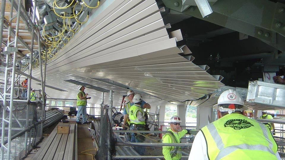 Stadium construction showing workers installing Versa-Dek® dovetail