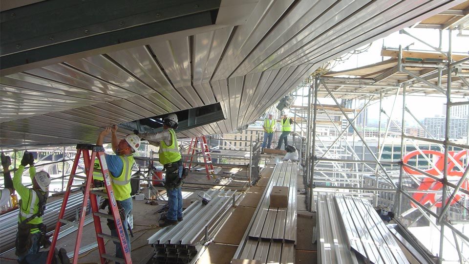 Stadium construction showing workers installing Versa-Dek® dovetail