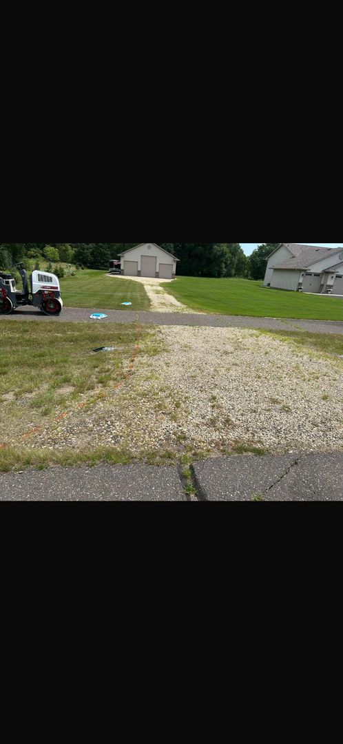 Worn driveway surface before tar & chip renovation
