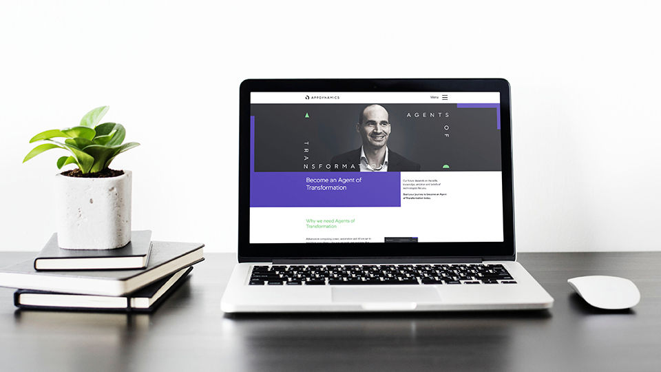 A laptop with the AppDynamics website branding displayed