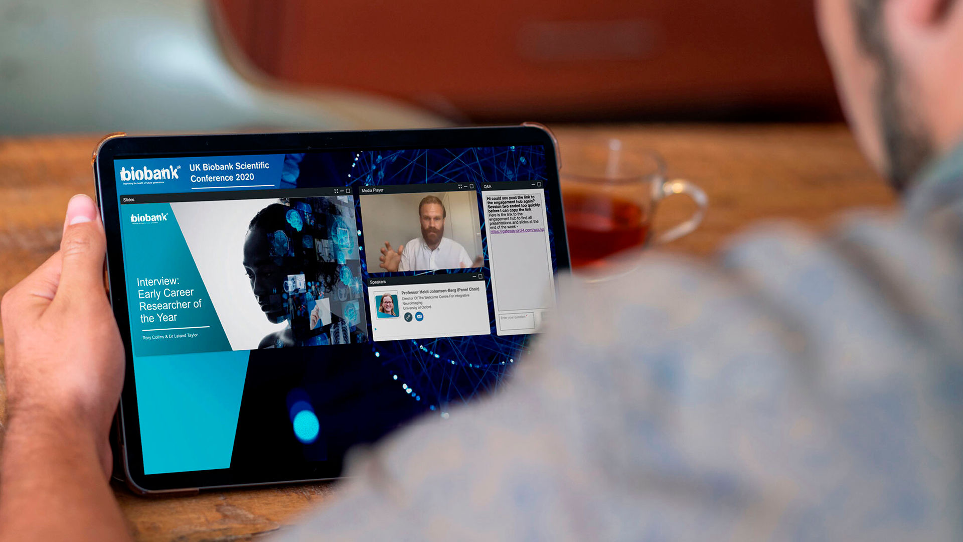 Over the shoulder view of someone looking at the BioBank website on a tablet device