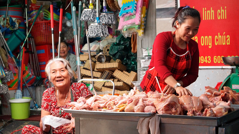 A market vendor selling various meats