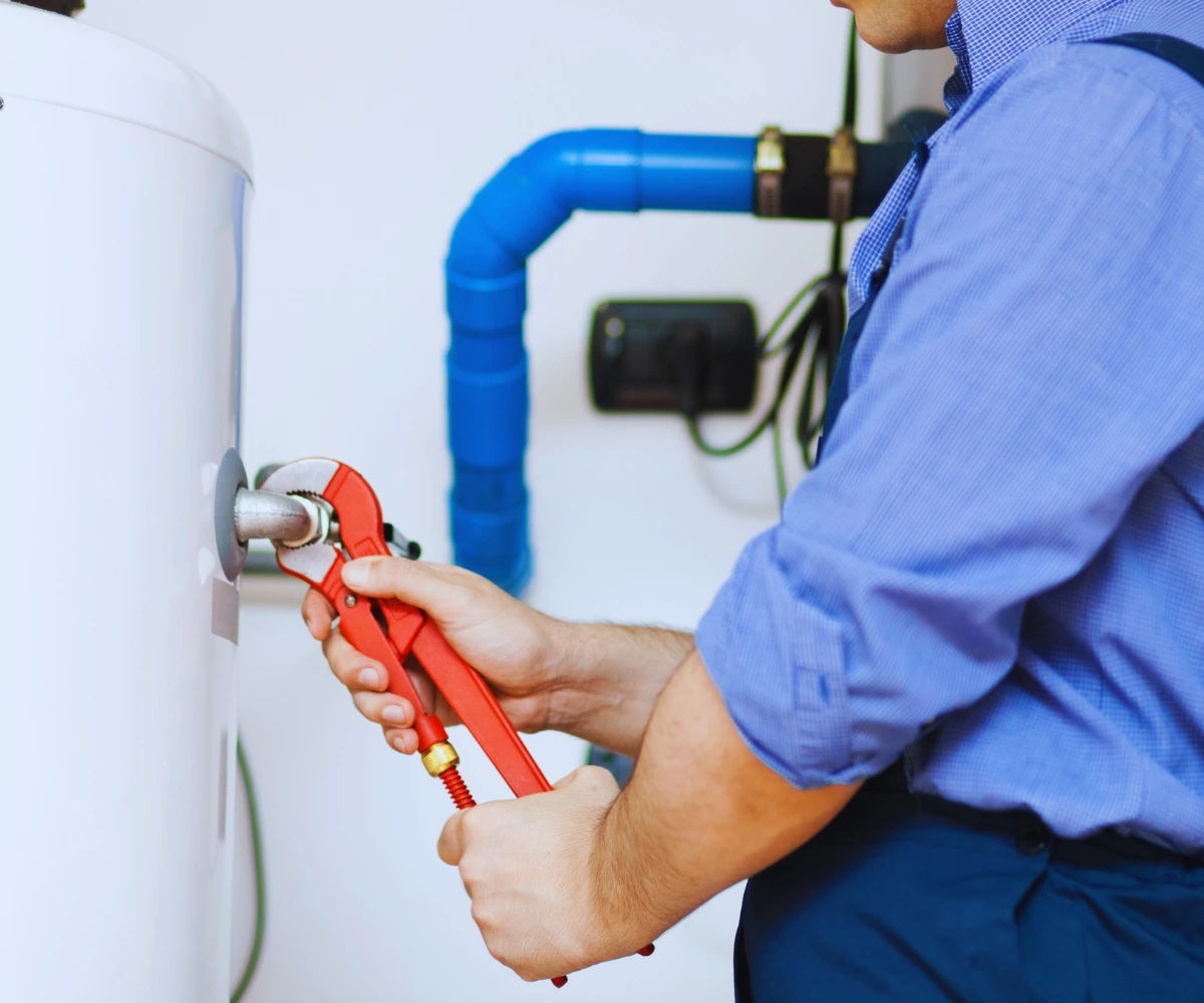 plumber fixing the hot water system Fixing Hot Water Heater Issues in Wet Winter Weather