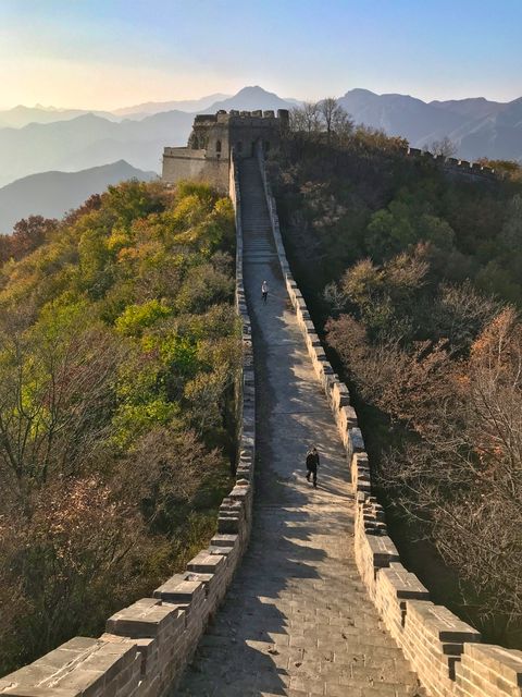 two people walking on the great wall