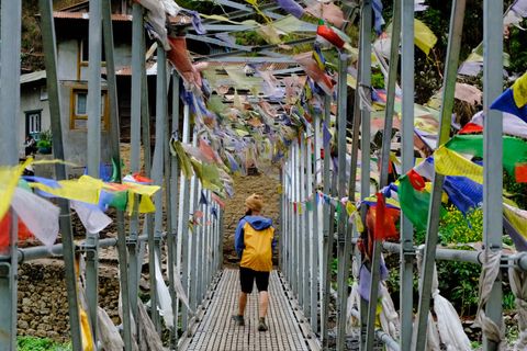 colorful prayer flags hanging suspension bridge