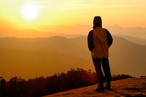 hiker silhouette sunset mountains