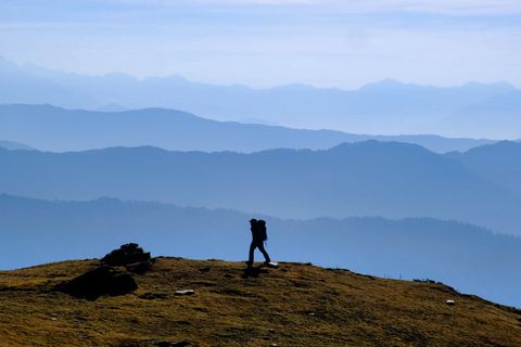 hiker silhouette walking in valley