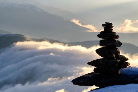 stone cairn on snowy mountain