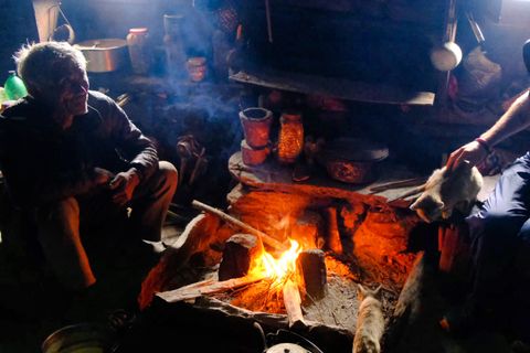 villagers gathered around campfire cooking