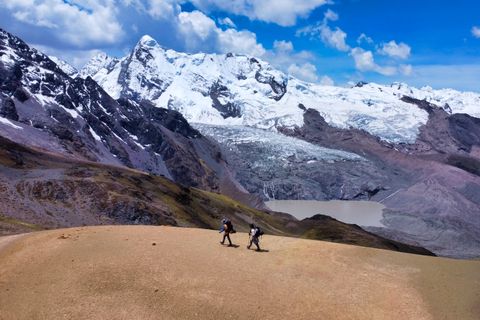 two hikers above a glacial lagoon