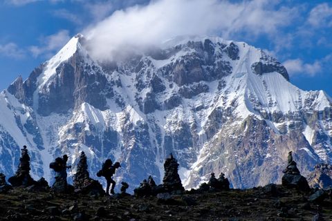 two hikers in front of ausangate mountain far away