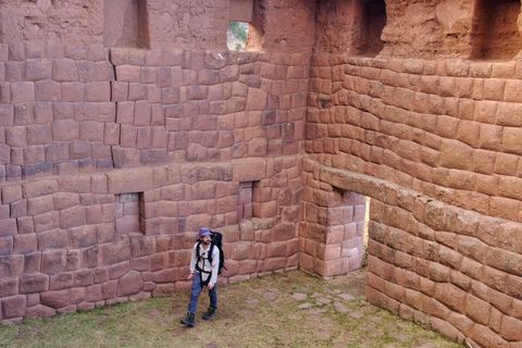 hiker walking around incan ruins