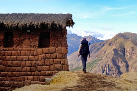 hiker walking next to incan ruins