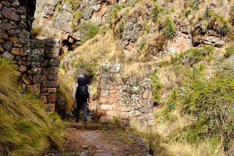 hiker walking through incan gate