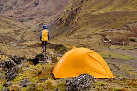 hiker at campsite overlooking valley