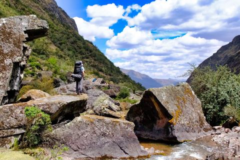 hiker standing on rock overlooking valley