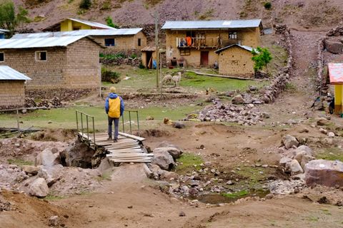 hiker walking over bridge in huacahuasi