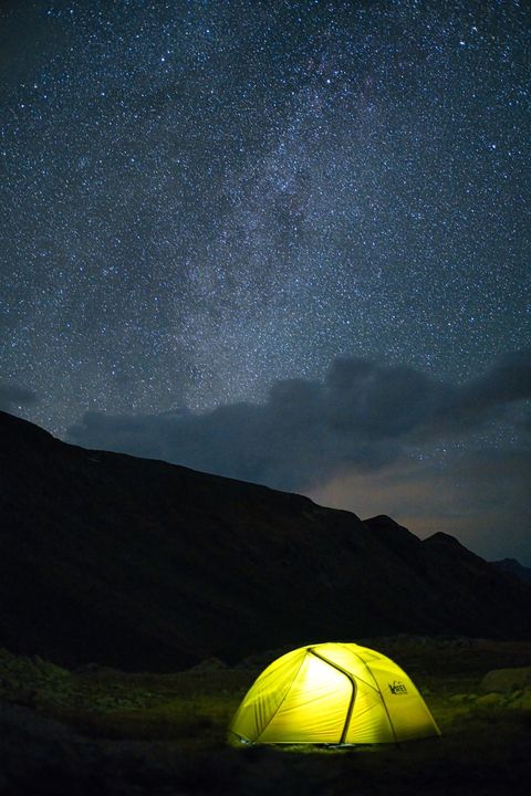 starry night campsite glowing tent