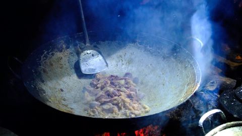 cooking meat in large wok