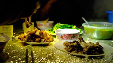 two plates of pork on dinner mat