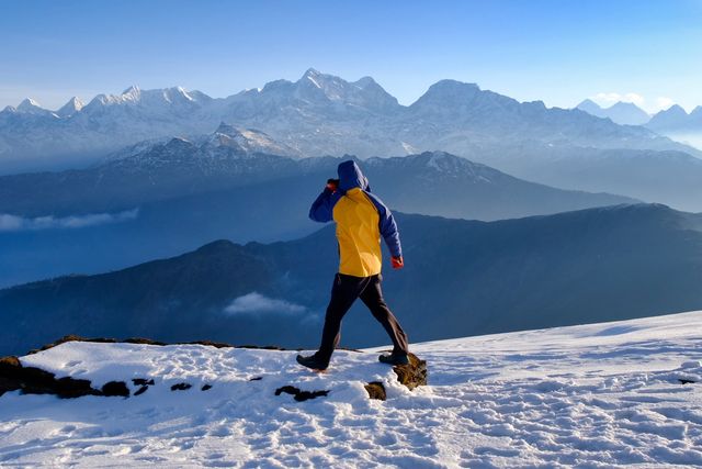 person hiking in snowy mountains