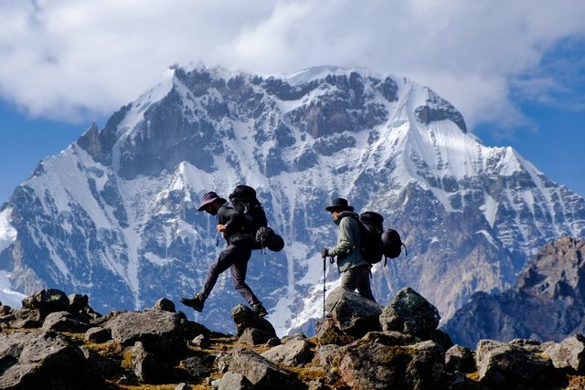 two hikers in front of ausangate mountain