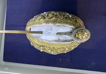 <p>This Hair pin and bun holder is from the Tyroler Volkskunstmuseum in Innsbruck. It is comprised of a piece of fabric that is stretched over the hair, and works in conjunction with a pin that is inserted to fasten the hair to the fabric. </p>