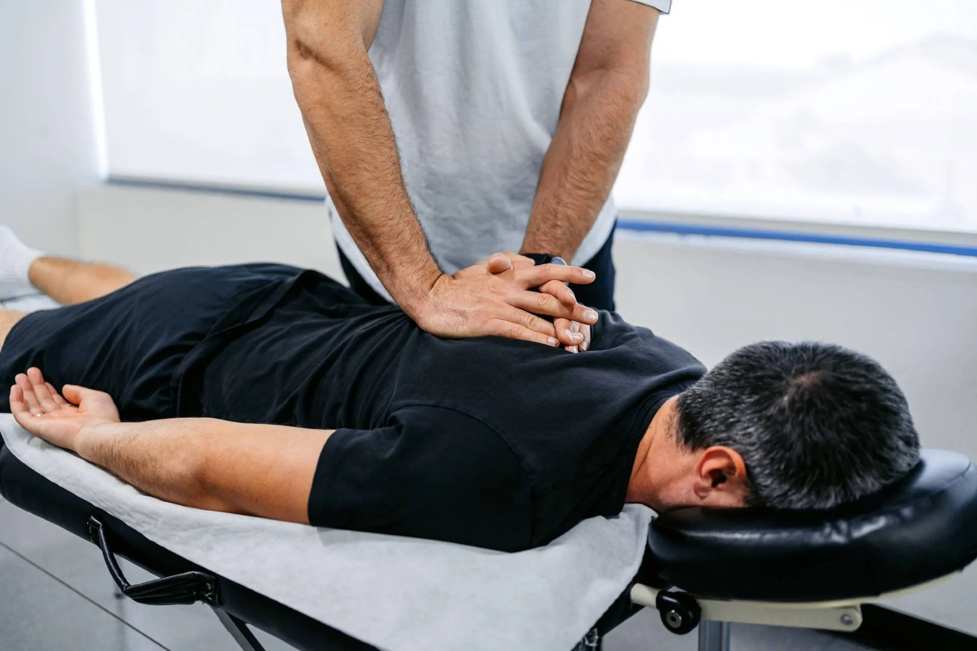 Chiropractic Massage Explained Chiropractic Massage Explained - ChiropractorAdjustingHisMaleClient27sUpperBackInHisOffice