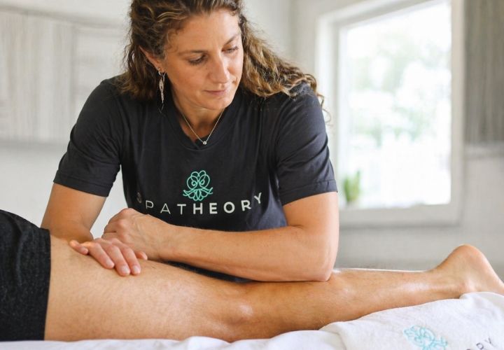 Sports Massage for Recovery: How It Helps You Train and Perform Better SpaTheory licensed massage therapist performing sports massage on a client's leg muscles during a recovery session
