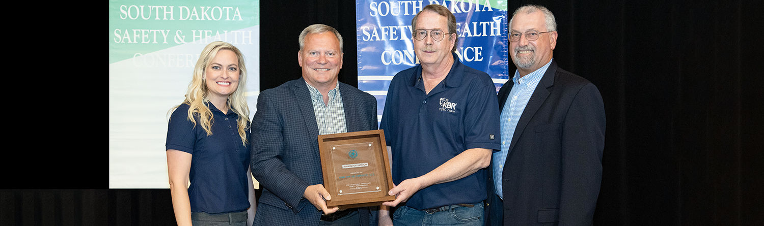 image of 4 leaders from KBR holding Governor's Safety award
