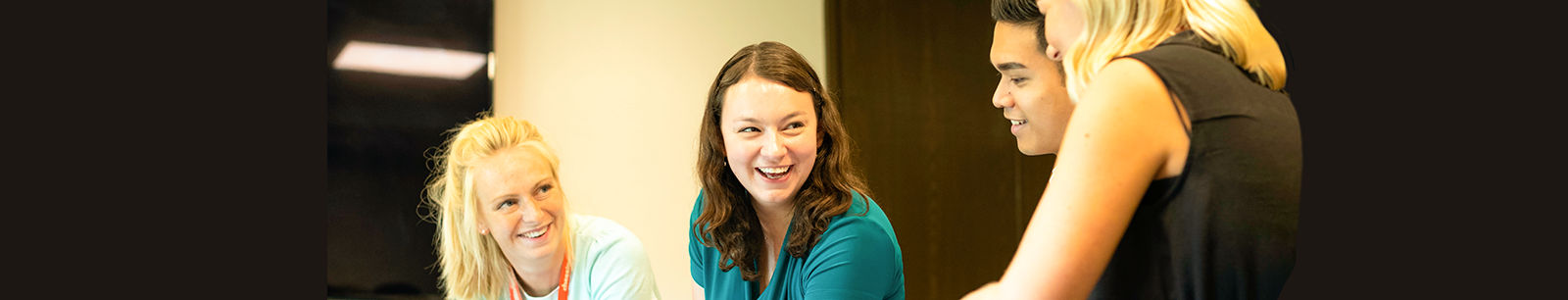 4 young professionals collaborating in an office setting