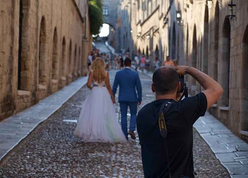 a wedding photographer is taking photos