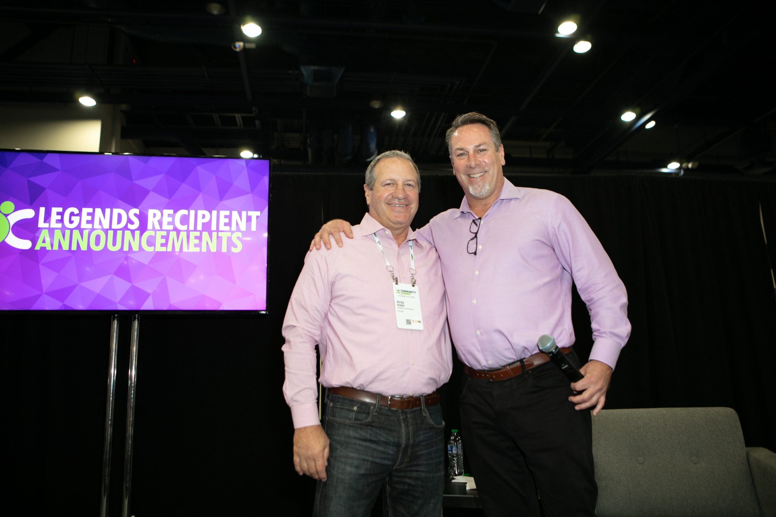A couple of men posing for a photo
Description automatically generated with low confidence