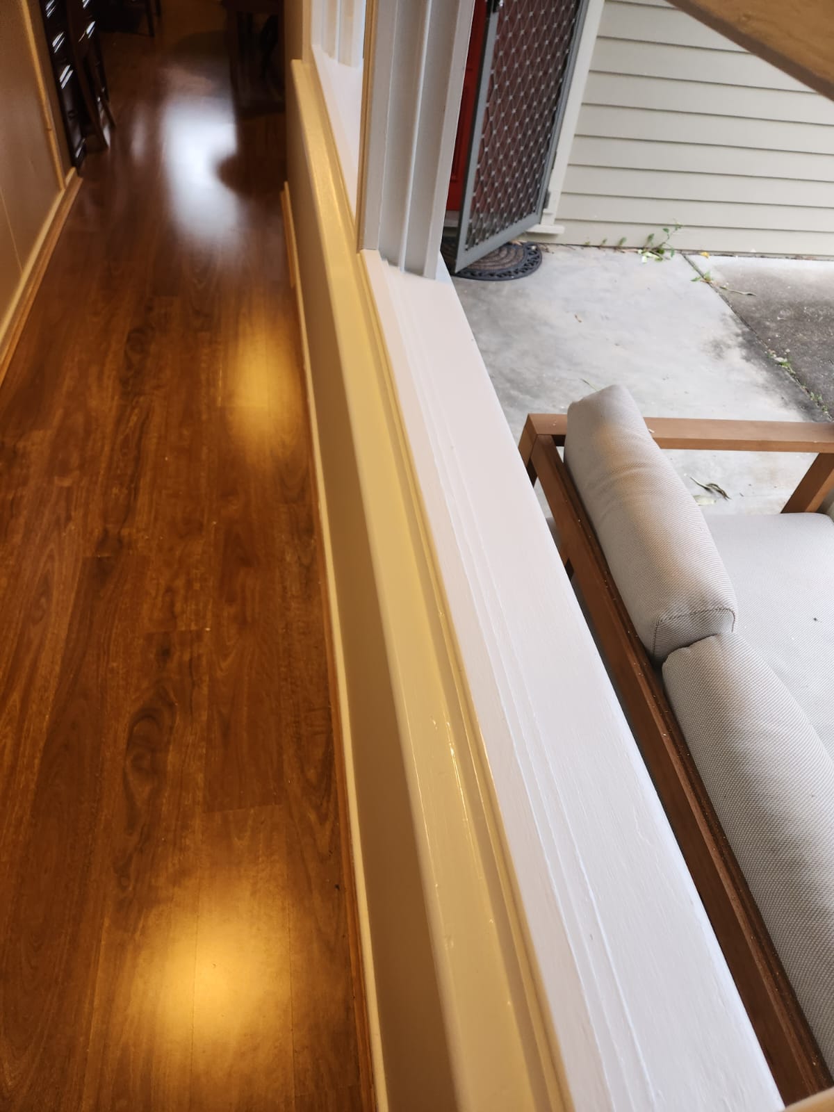Interior hallway with freshly painted white trim beside a polished timber floor